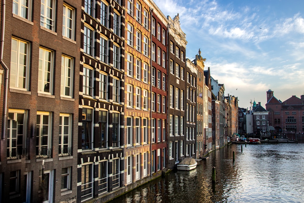 a row of buildings next to a body of water