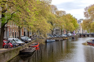 a canal with several boats parked along it