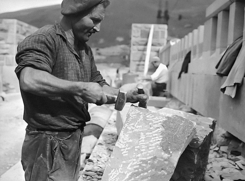 ein Schwarz-Weiß-Foto eines Mannes, der an einem Kunstwerk arbeitet