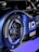 A close-up of a car's rear wheel featuring Bridgestone Potenza tires. The car has a sleek, modern design with a blue and black color scheme. The logo and branding for Volkswagen ID and Castrol are visible, suggesting it is a high-performance electric vehicle.
