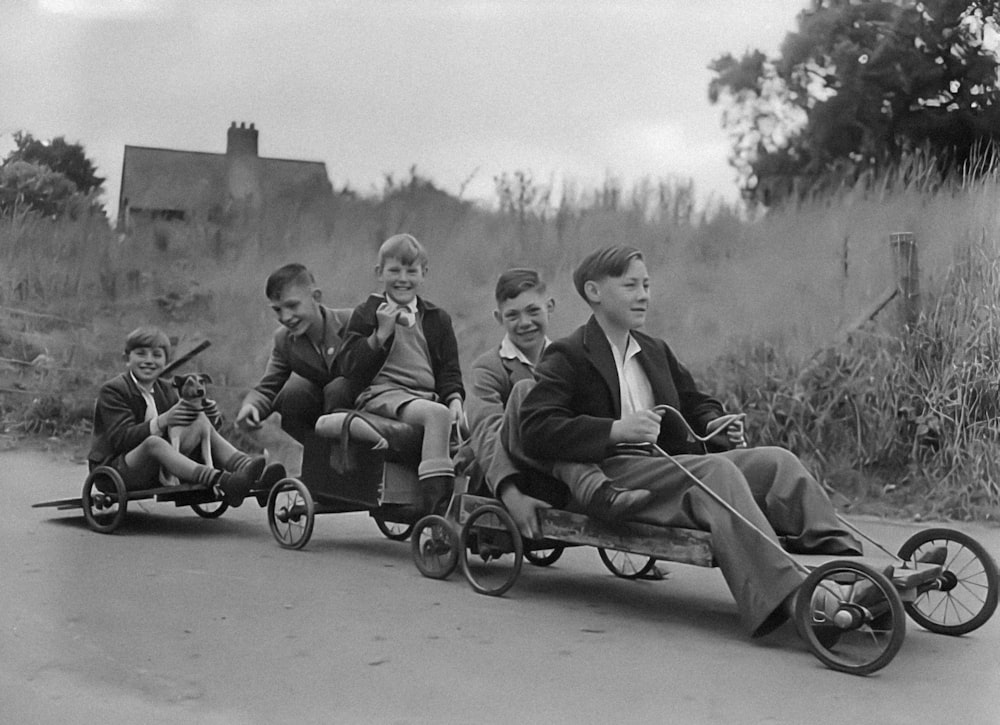 a black and white photo of a group of people riding on a three wheeled cart