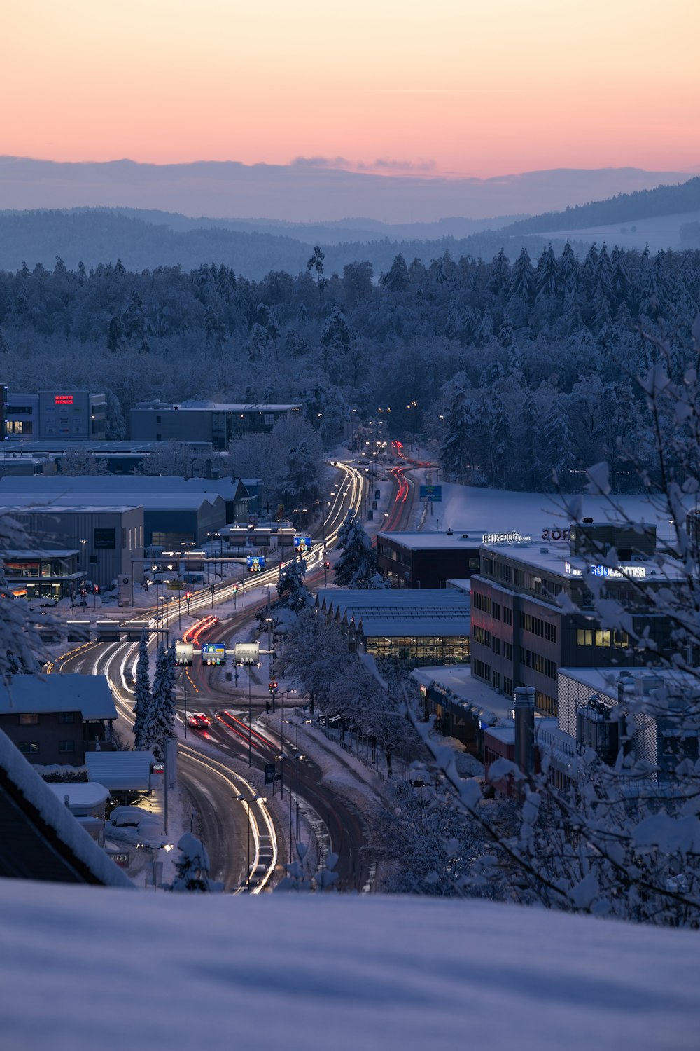a view of a snowy city at dusk