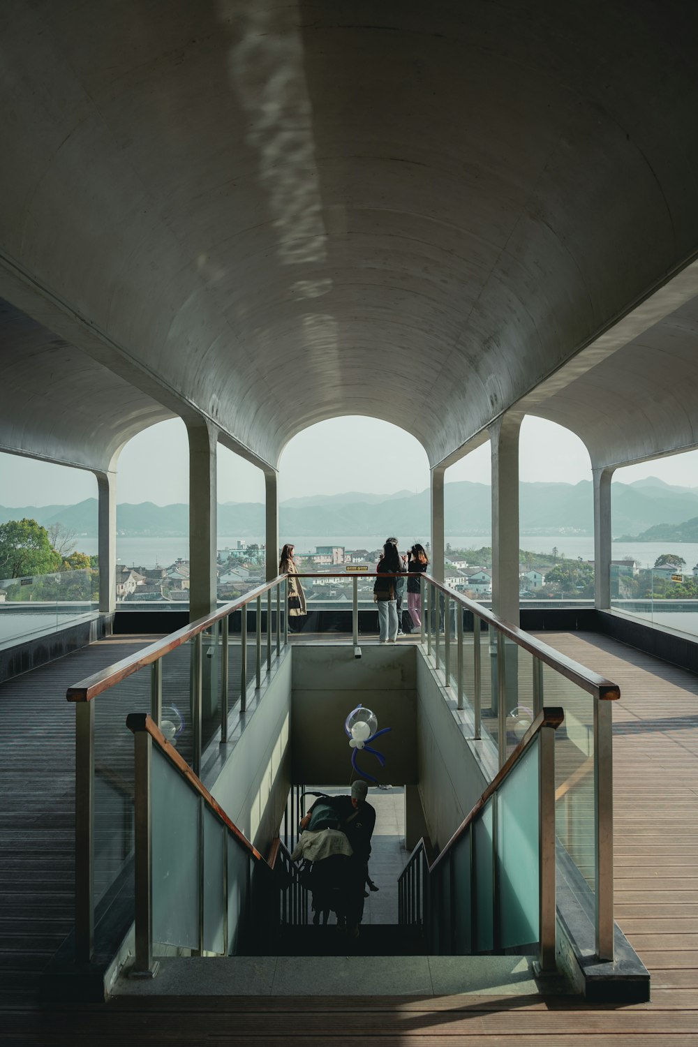 a group of people standing on top of a wooden walkway