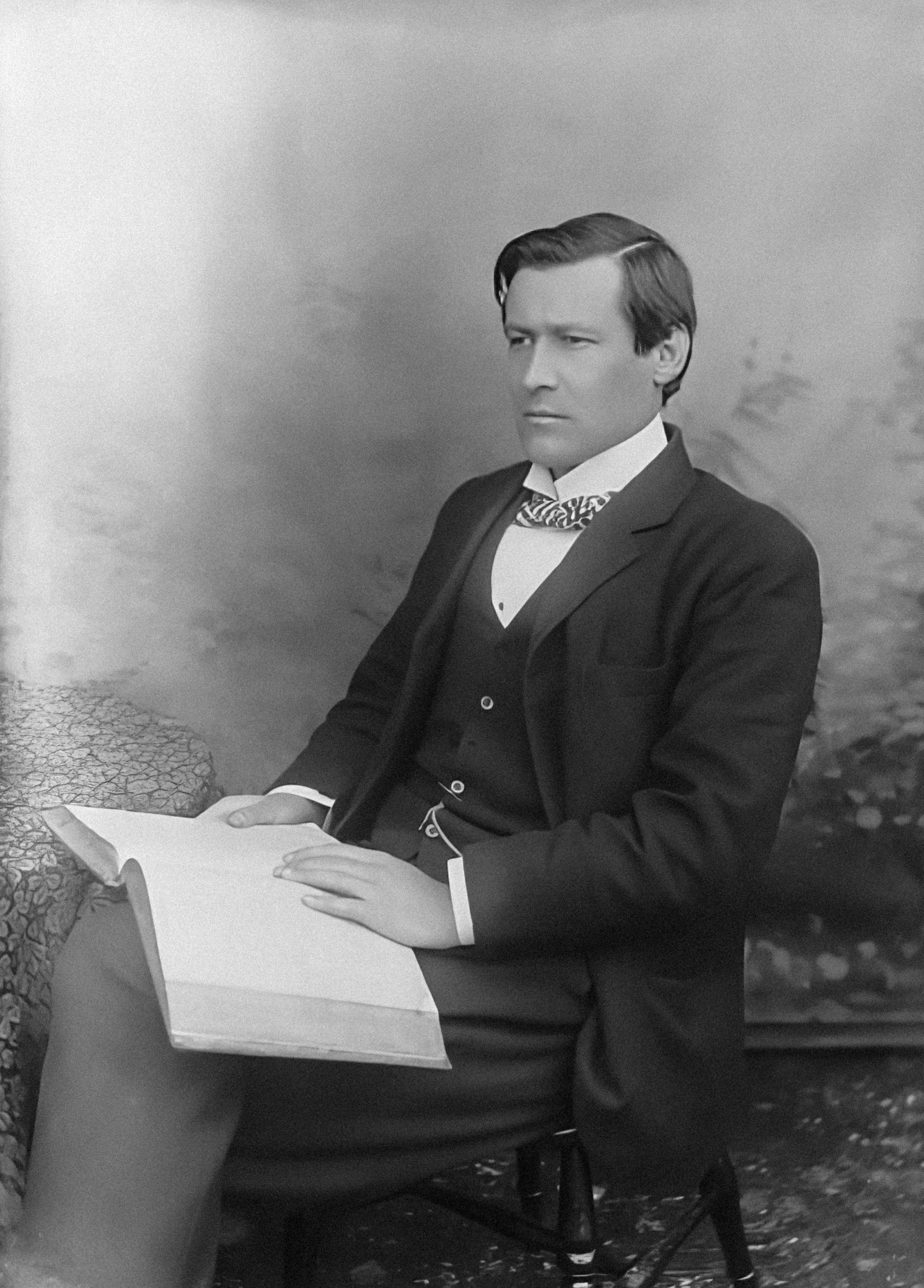 Une photo en noir et blanc d’un homme en costume