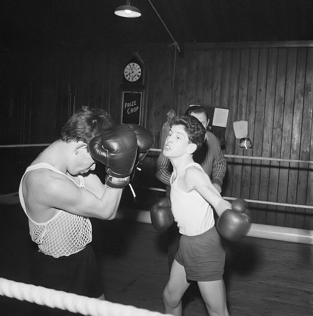 a black and white photo of a woman in a boxing ring