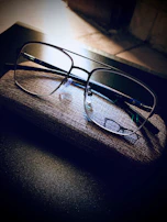 A set of eclipse glasses and a protective carrying case displayed on a dark cloth.