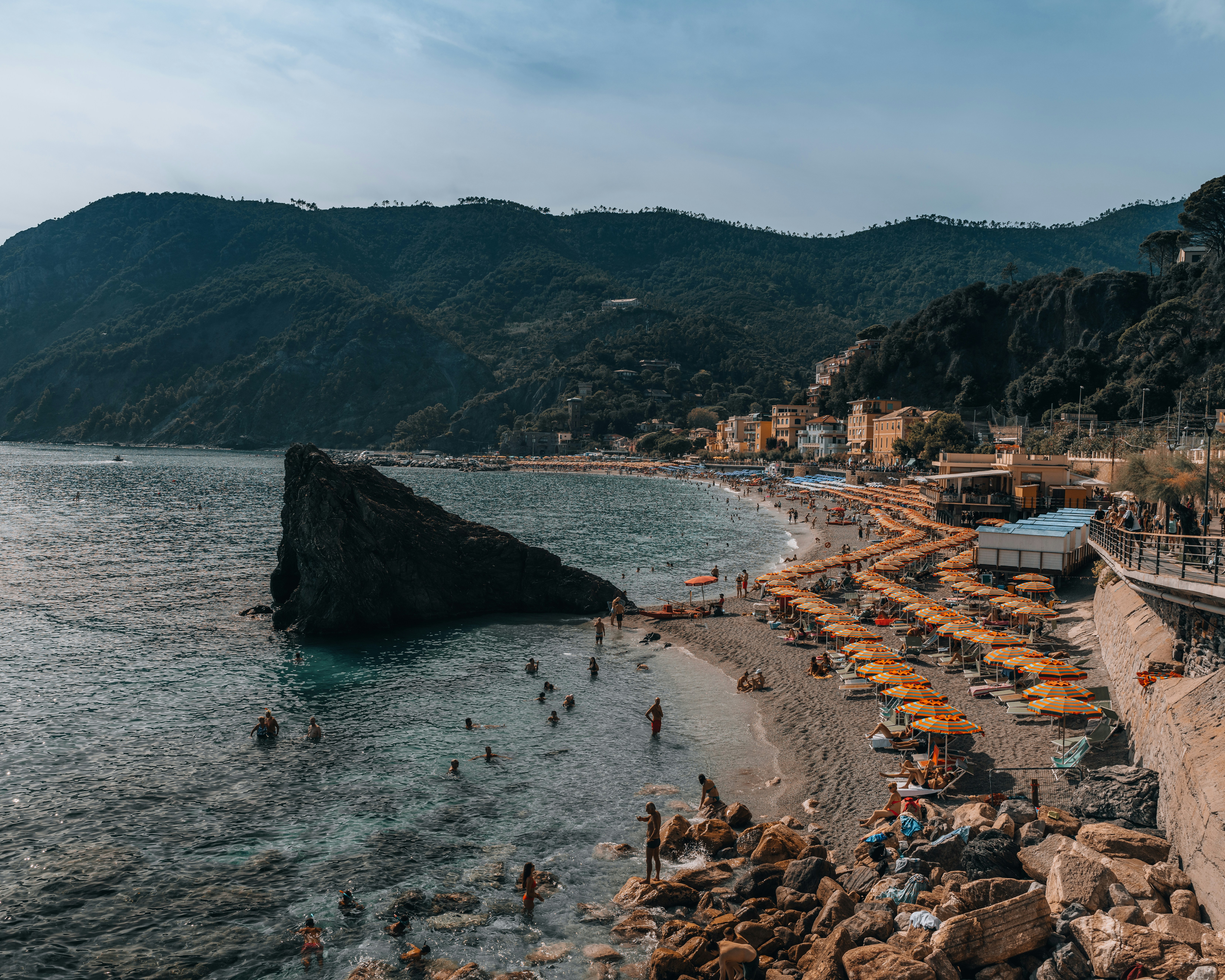 a group of people on a beach with umbrellas