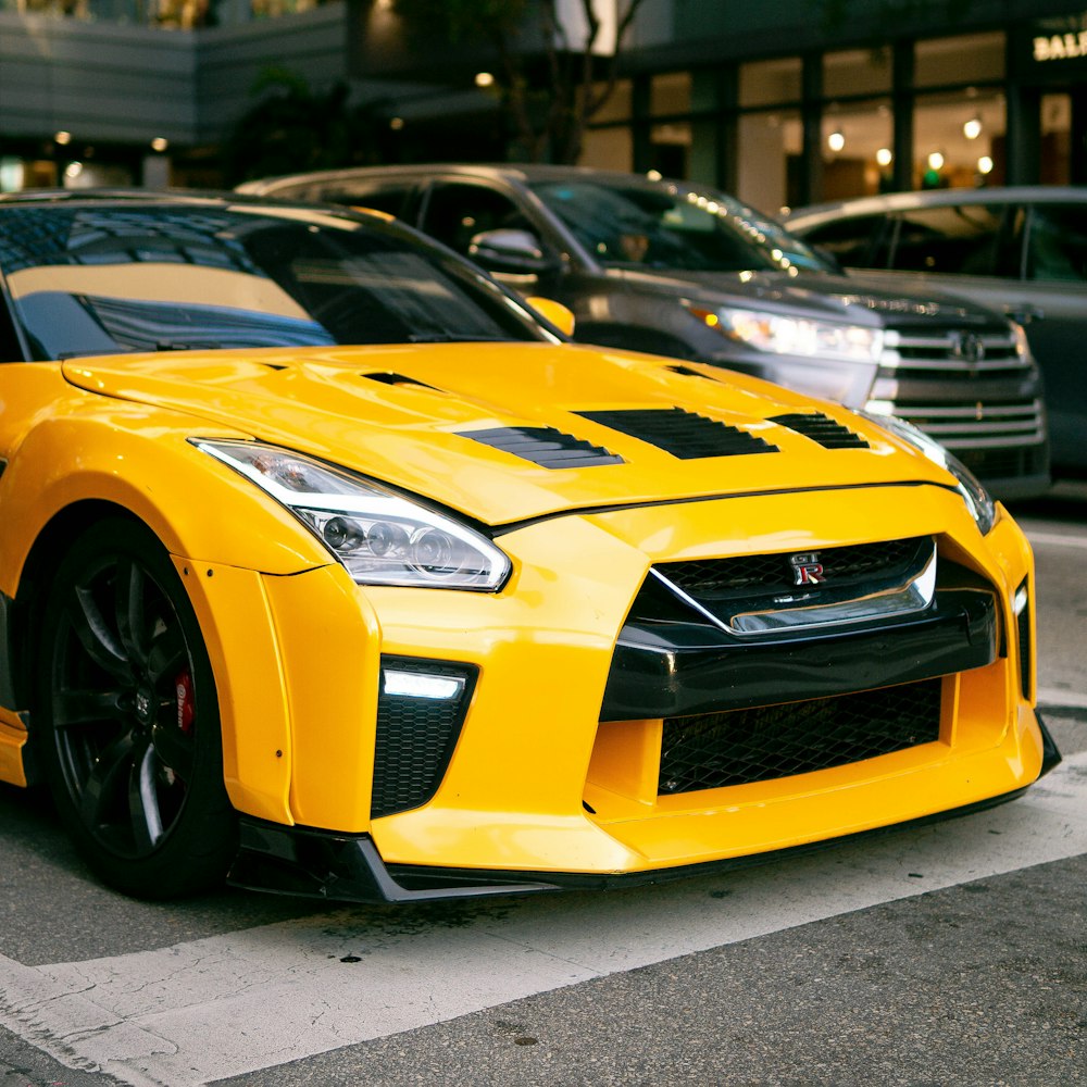 a yellow sports car parked on the side of the road