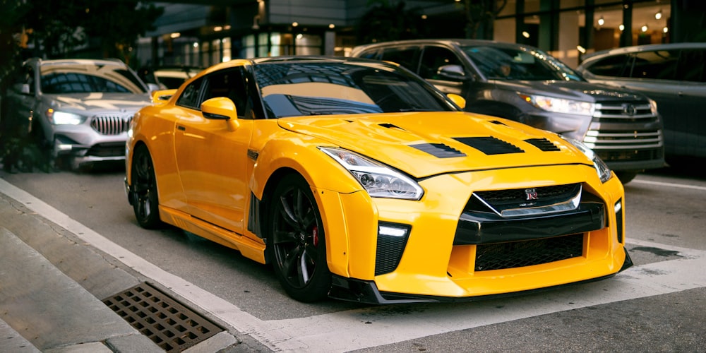 a yellow sports car parked on the side of the road