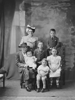 a black and white photo of a family posing for a picture