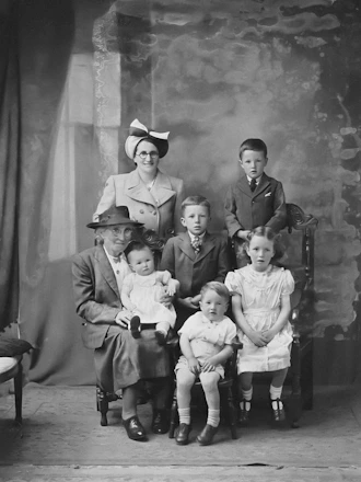a black and white photo of a family posing for a picture