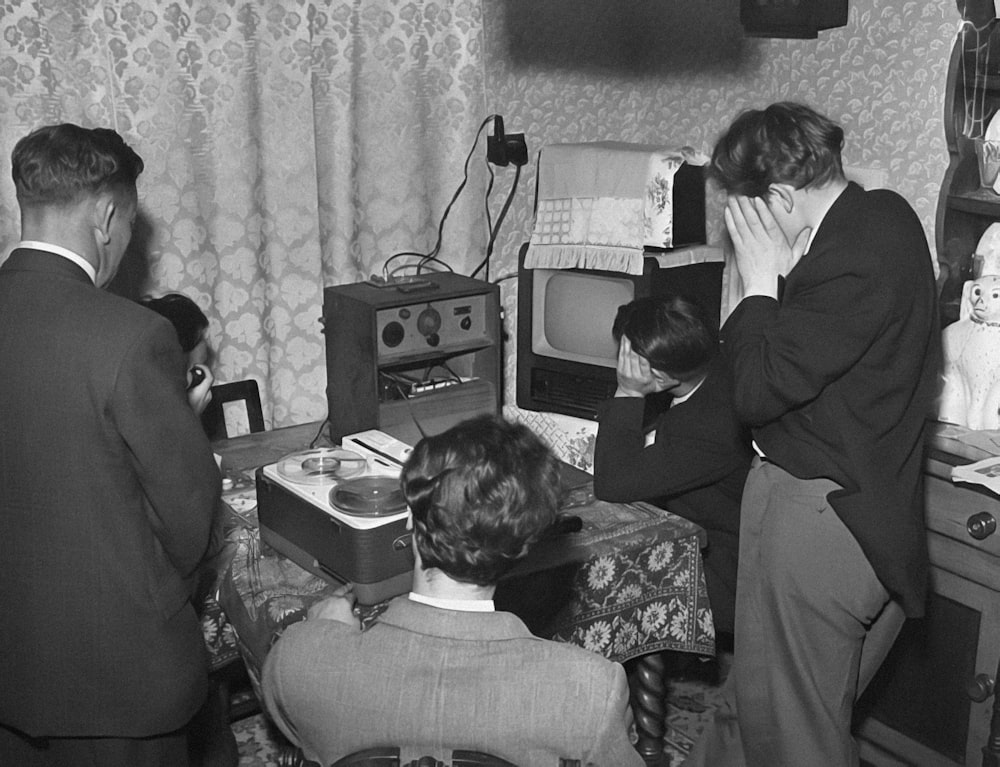 a black and white photo of people in a living room