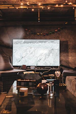 A cozy living room scene with a glowing TV screen displaying the nikknok logo, inviting viewers to stay tuned.