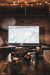 Cozy finished basement featuring warm lighting and comfortable seating.