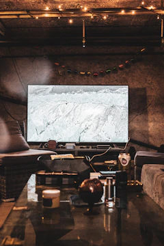 Cozy finished basement featuring warm lighting and comfortable seating.