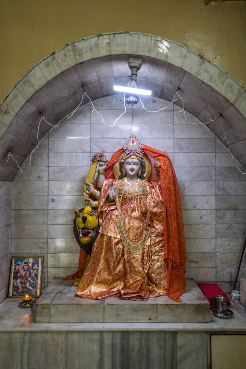 a statue of a person dressed in a golden outfit