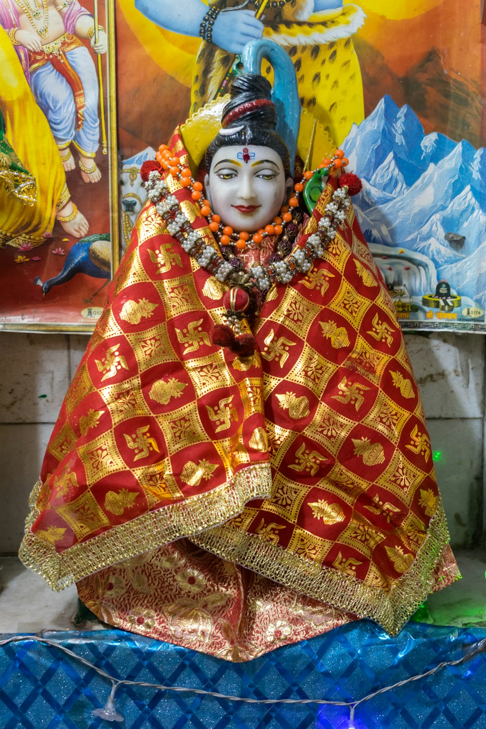 a statue of a person in a red and gold outfit