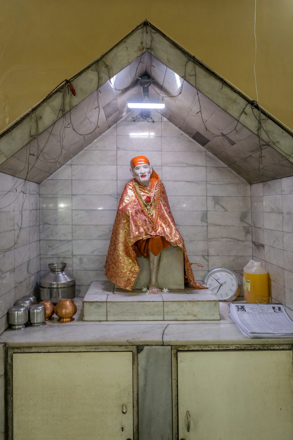 a statue of a person sitting on top of a counter