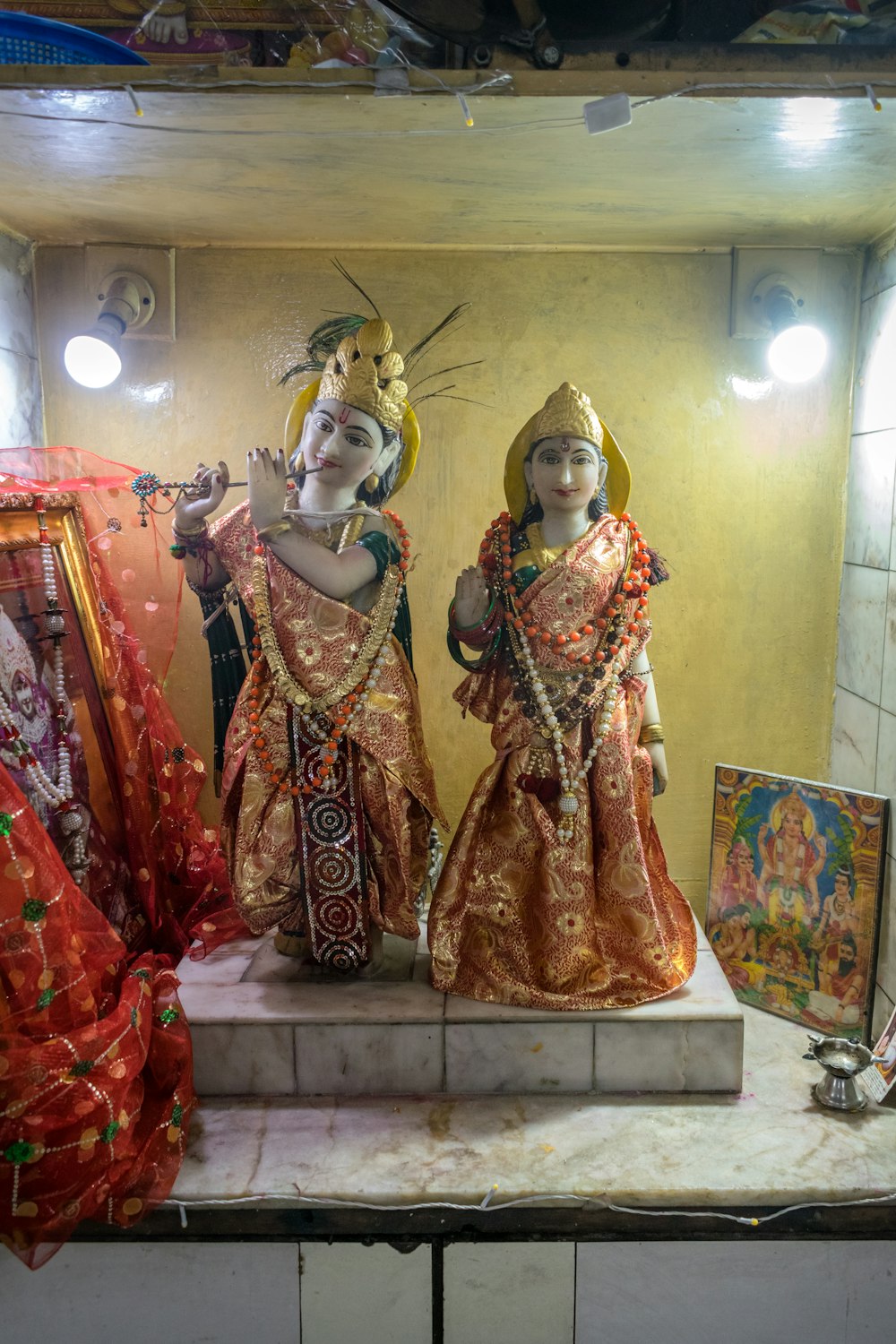 a couple of statues sitting on top of a counter