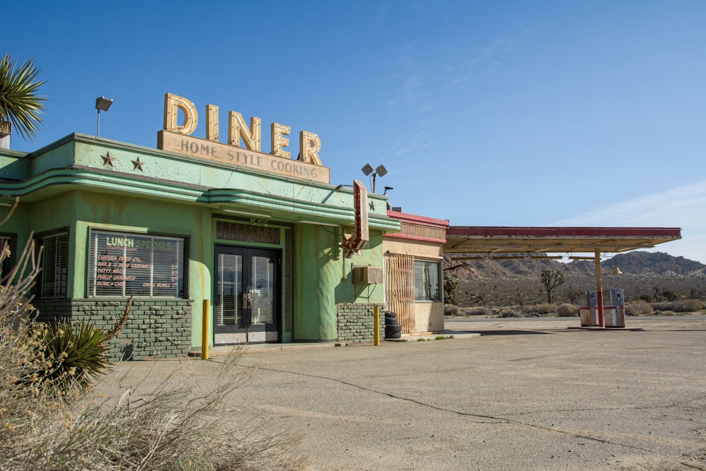a green building with a sign that says diner
