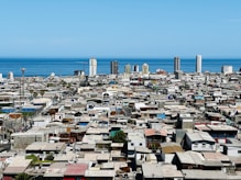 a view of a city with a body of water in the background