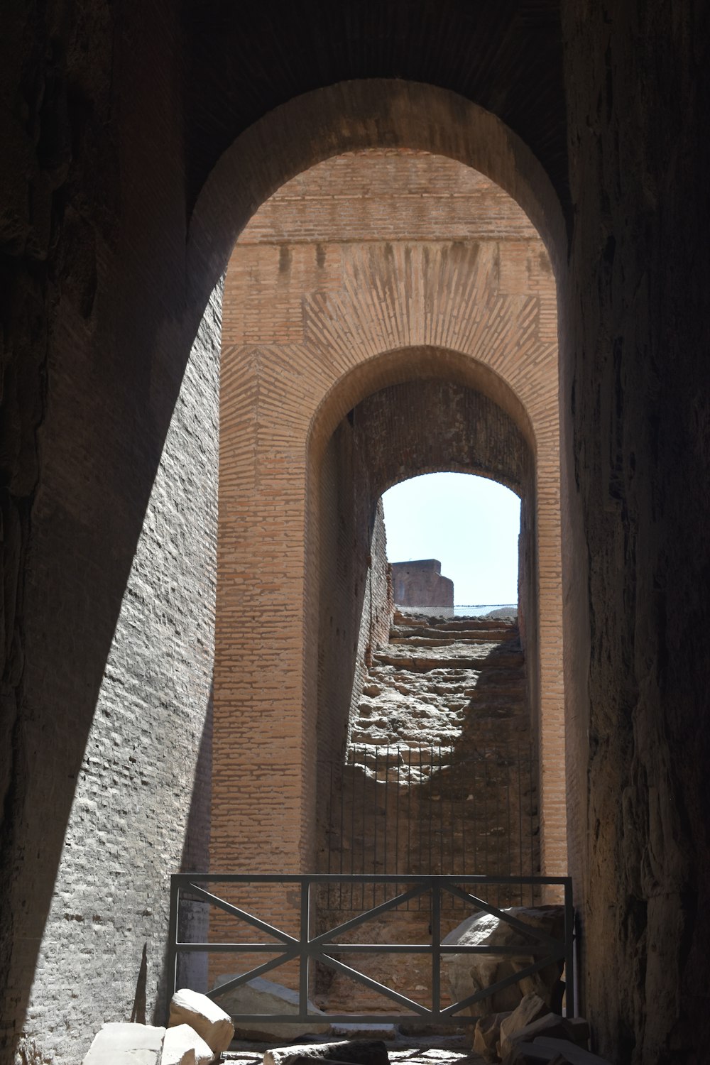 an arch in a brick wall with a gate