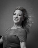 Vibrant colored portrait of a smiling woman with flowing hair.