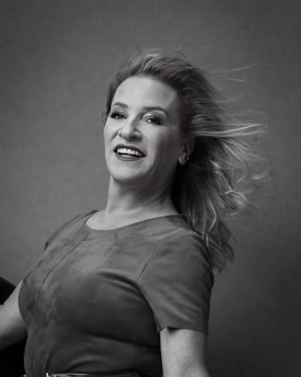 Portrait of a smiling young woman in a casual setting, representing a satisfied client.