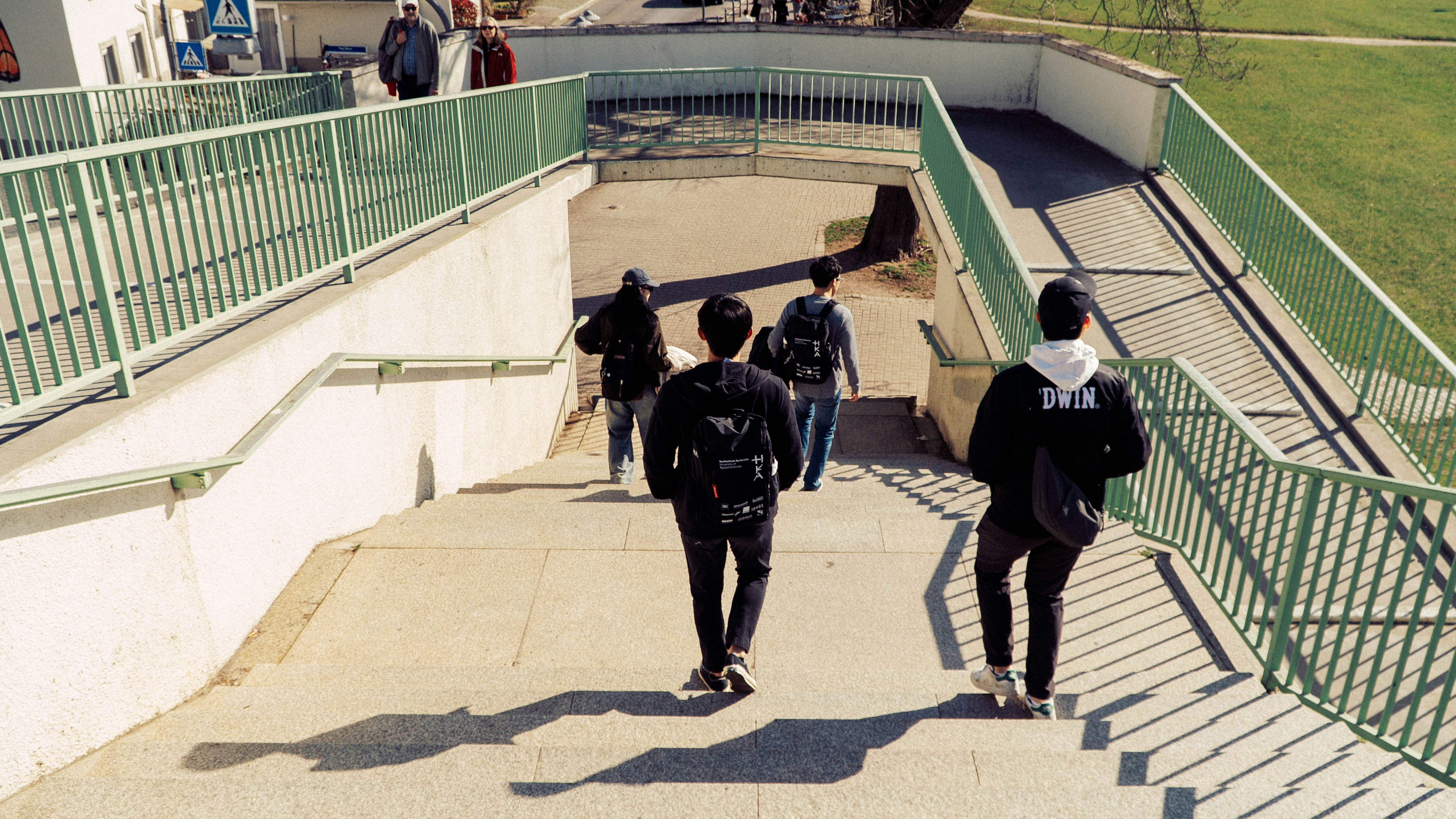 A group of people walking up a flight of stairs photo – Free Walking ...