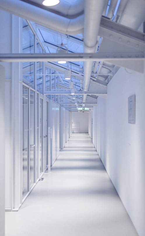 a long white hallway with lots of windows