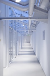 a long white hallway with lots of windows