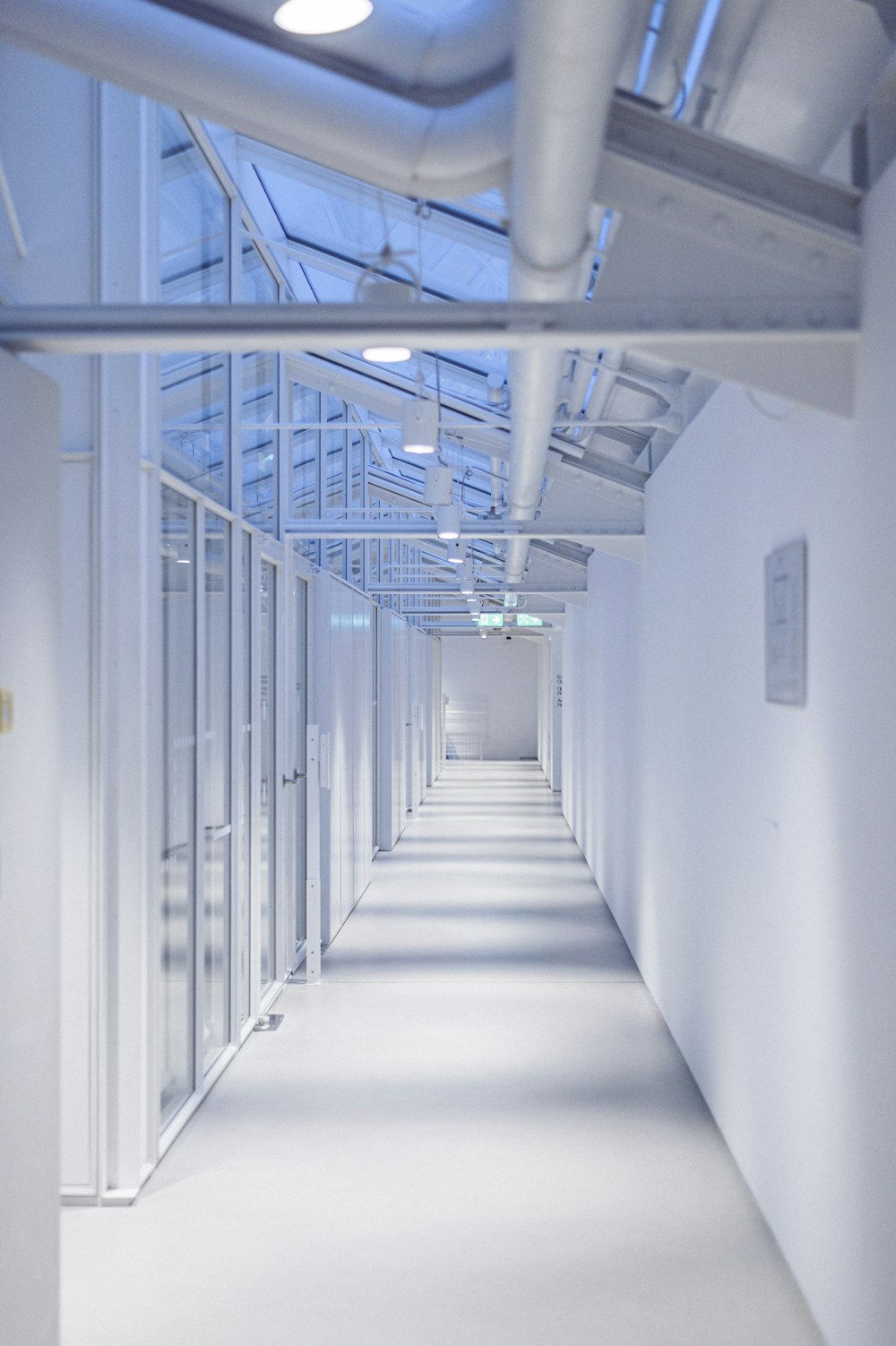 a long white hallway with lots of windows