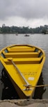 a small yellow boat floating on top of a lake