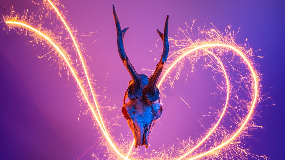 a deer's head is surrounded by firework