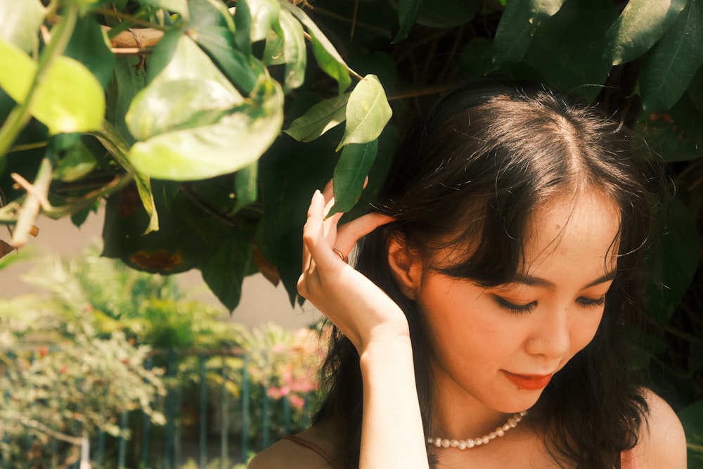 a woman with a pearl necklace and a pearl necklace