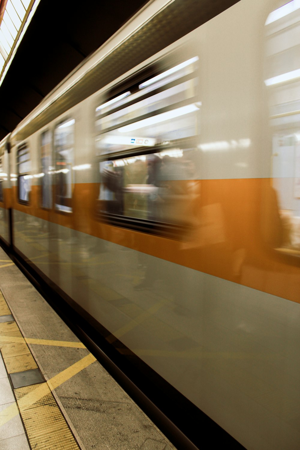 a train is speeding past a station platform