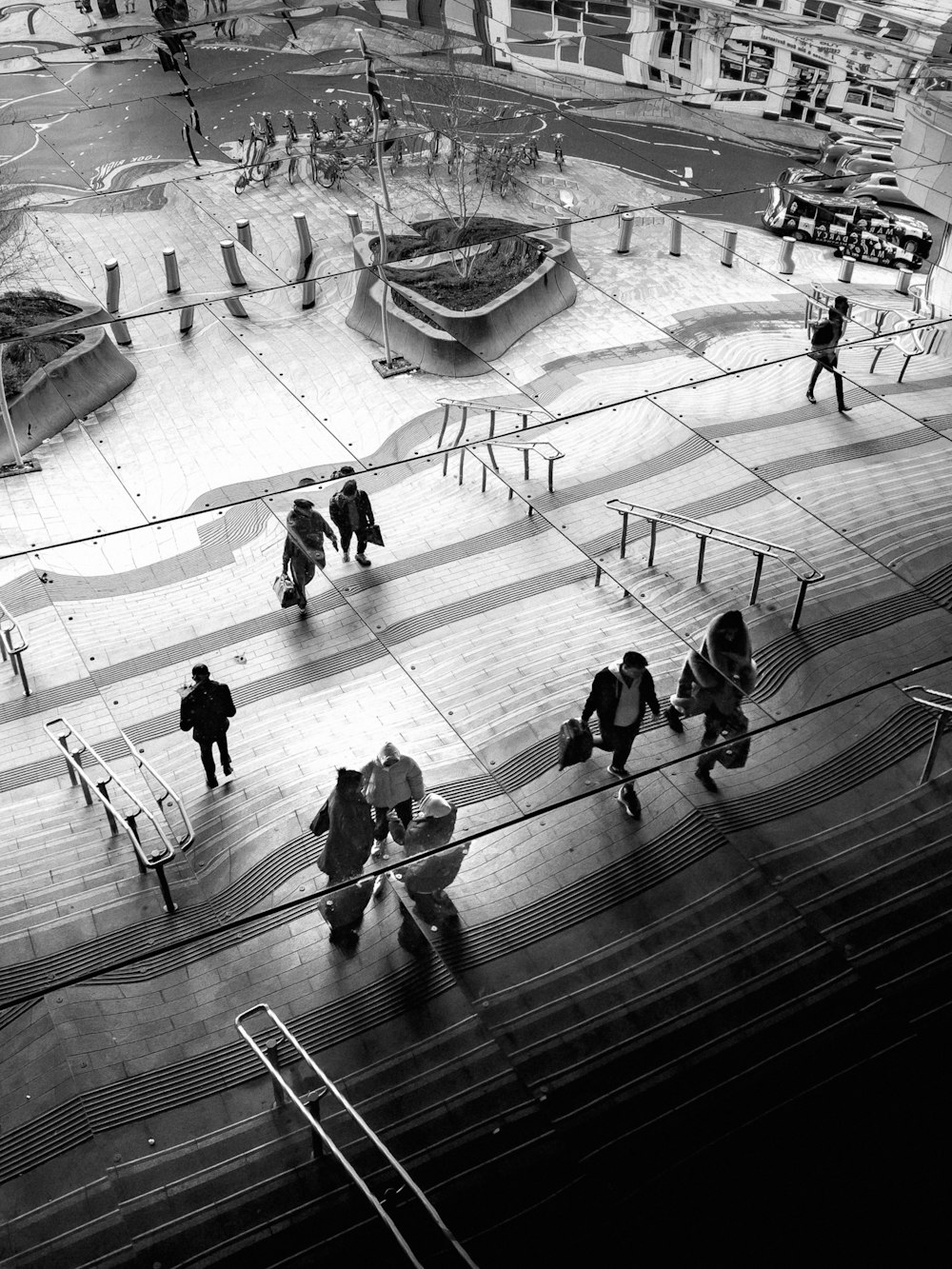 a black and white photo of people walking up stairs