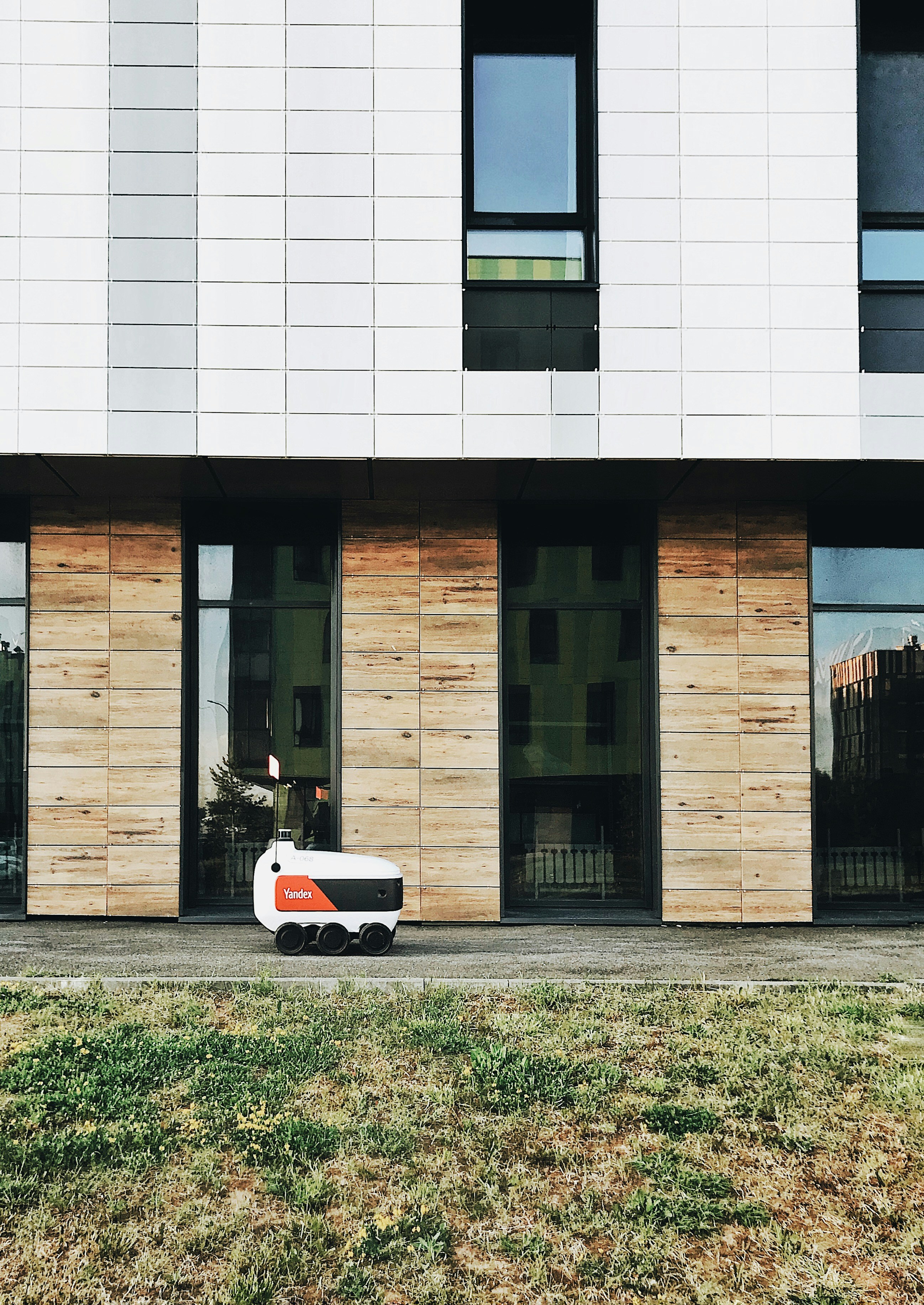 a white and orange vehicle parked in front of a building