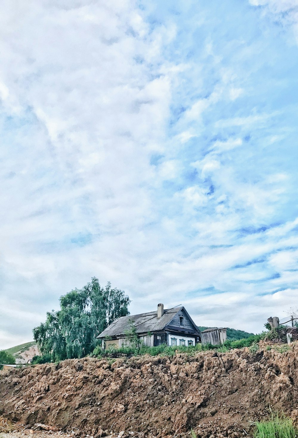 a house sitting on top of a pile of dirt