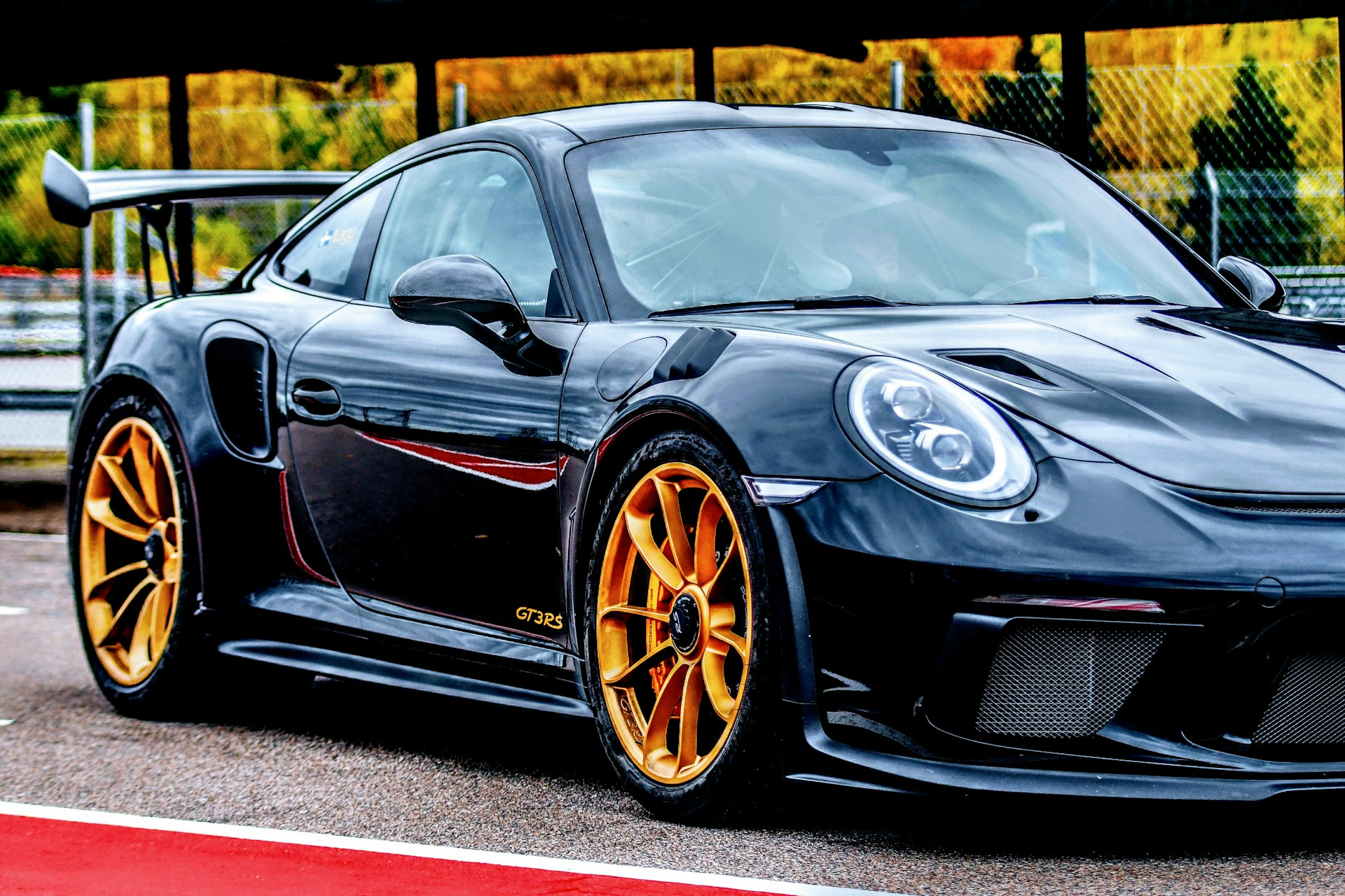 a black sports car parked in front of a building