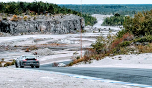 Dynamic shot of a sporty hatchback driving through a winding road