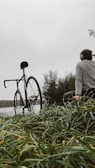 Friends gathered on a bench sharing headphones, with colorful bikes parked nearby under a deep green gradient sky.