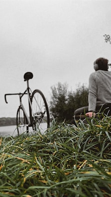 Friends gathered on a bench sharing headphones, with colorful bikes parked nearby under a deep green gradient sky.