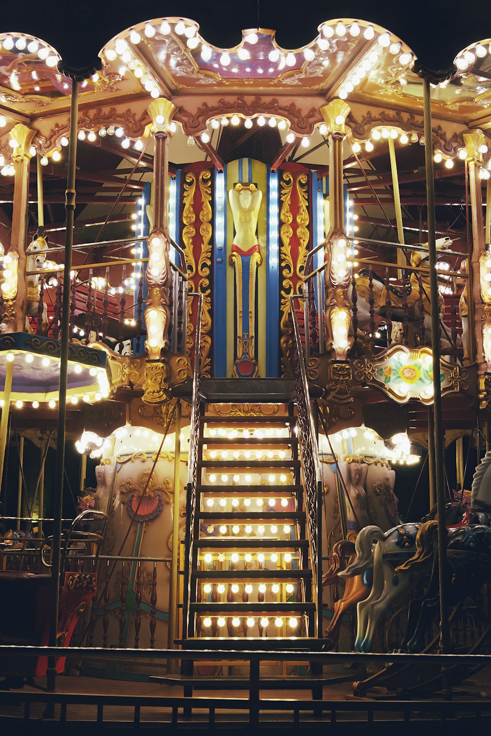 a carousel at night with many lights on it