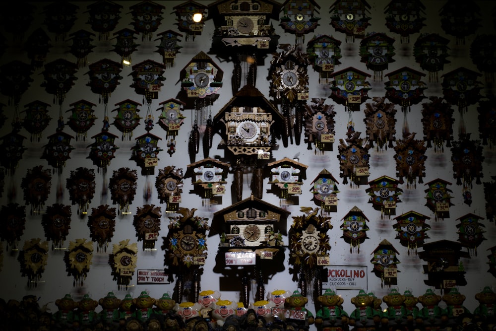 a bunch of clocks that are on a wall