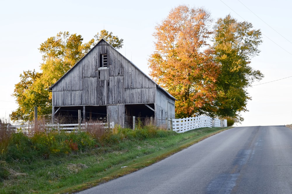 an old barn on the side of a country road