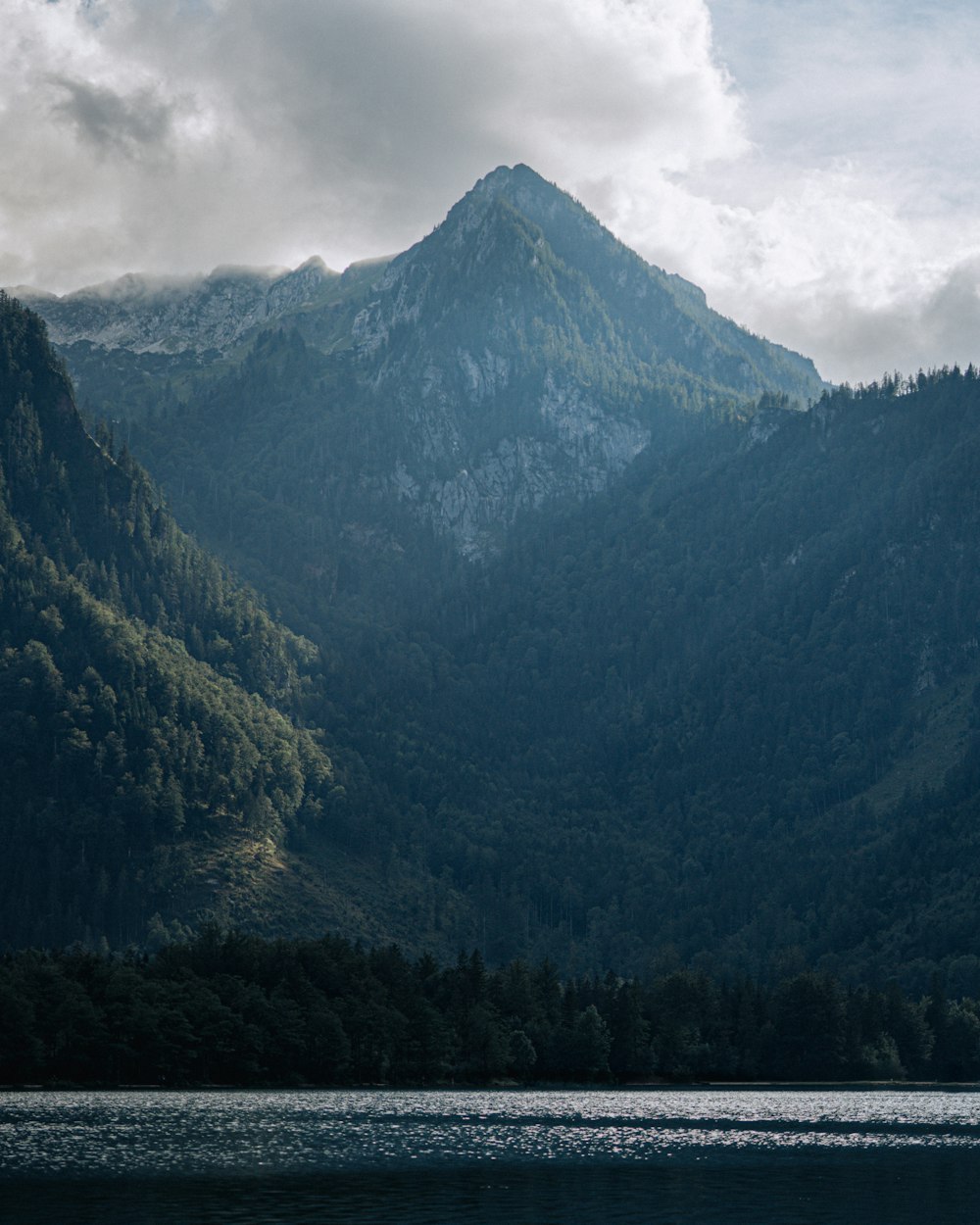 a mountain range with a body of water in front of it