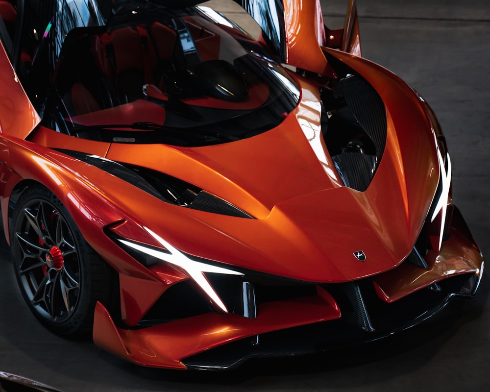 an orange sports car parked in a garage