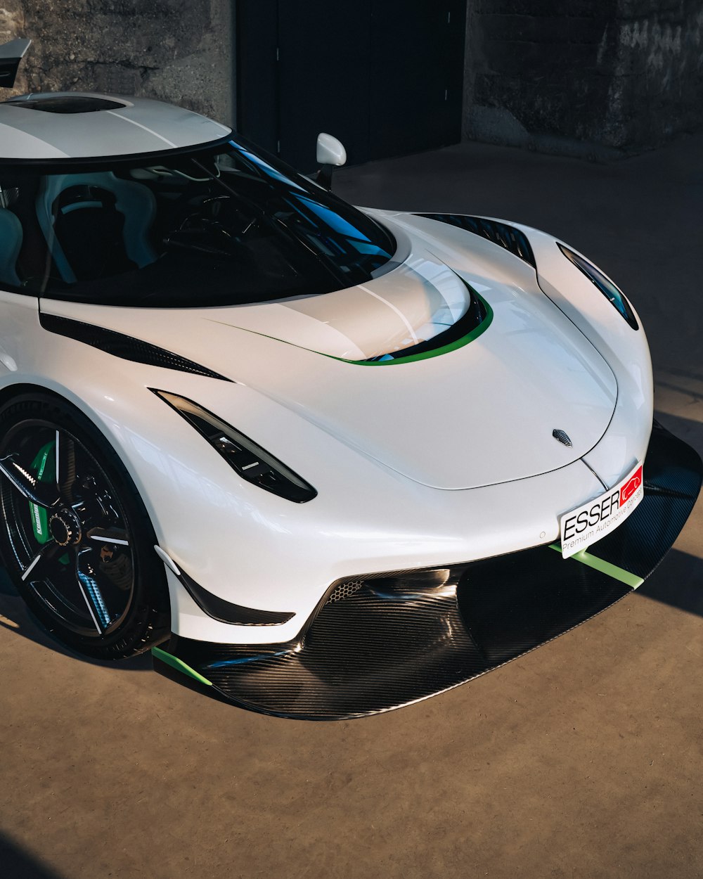 a white sports car parked in a parking lot