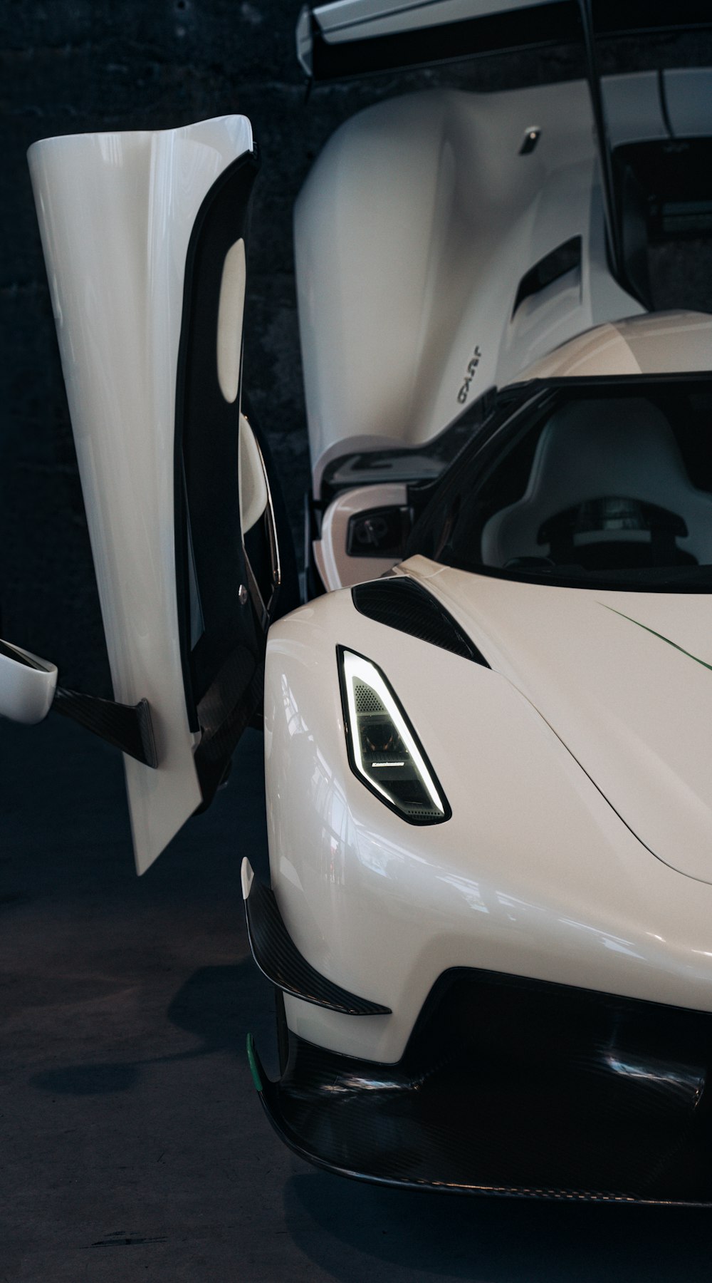 a white sports car parked in a garage